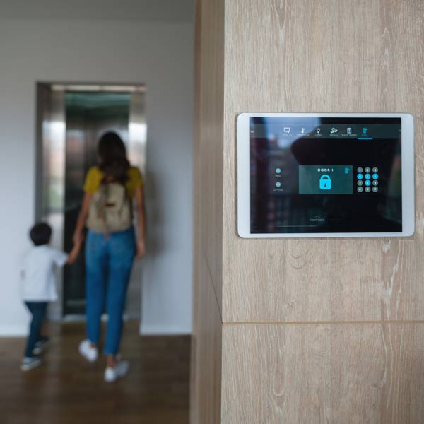 condo alarm system with mom and son walking away